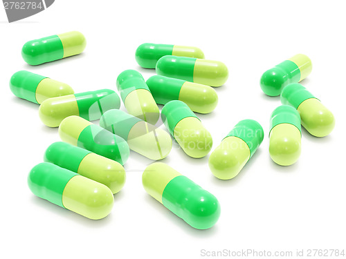 Image of Many green pills on white