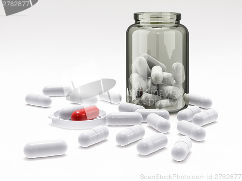 Image of White and red pills in medical bottle on white