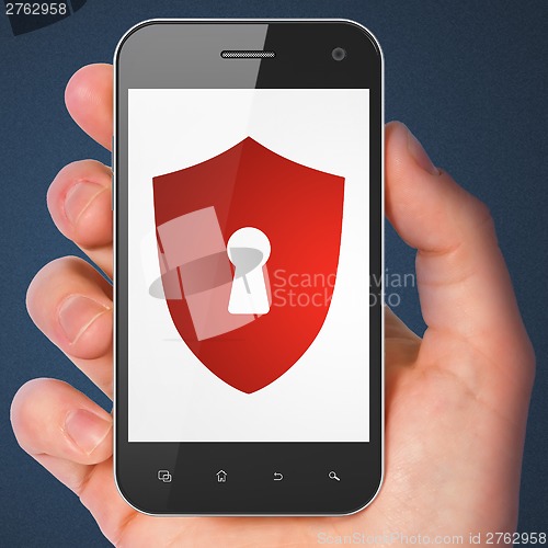 Image of Hand holding smartphone with shield keyhole