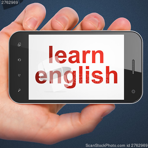 Image of Hand holding smartphone with word learn english