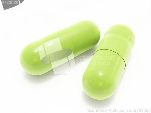 Image of Two green pills on white