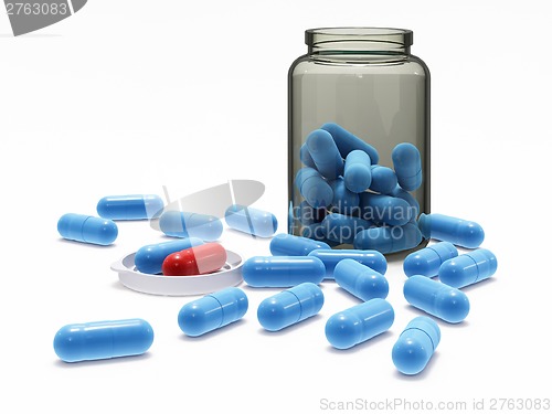 Image of Blue and red pills in medical bottle with cap