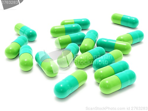 Image of Many two-colored pills on white