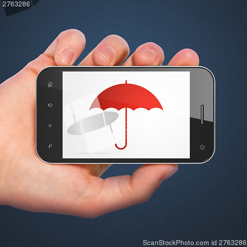 Image of Hand holding smartphone with Umbrella on display