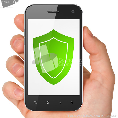 Image of Hand holding smartphone with shield on display