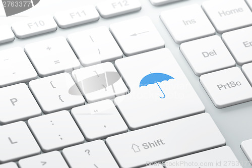 Image of Safety concept: computer keyboard with Umbrella