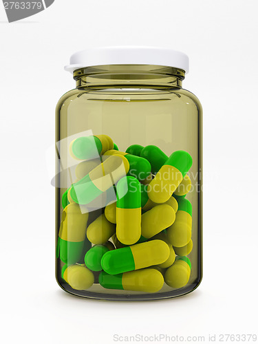 Image of Green-yellow pills in medical bottle on white