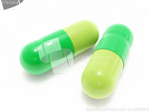 Image of Two green pills on white