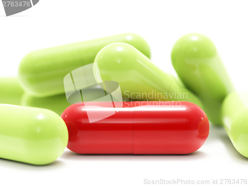 Image of Red and green pills on white
