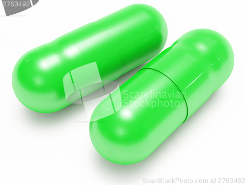 Image of Two shiny green pills (medical capsules)