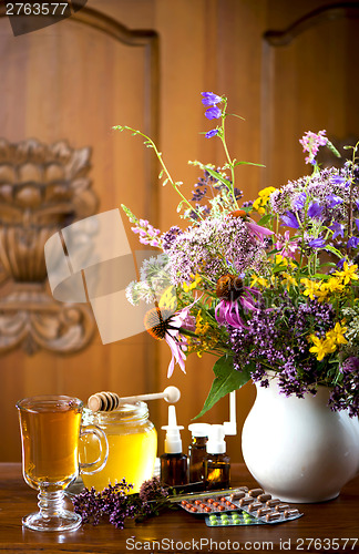 Image of Still life from medicinal herbs, honey, herbal tea and medicines