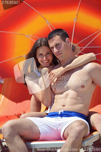 Image of happy couple have fun on the beach