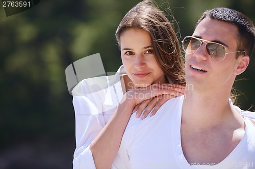 Image of happy couple have fun on the beach