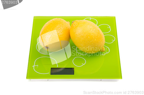 Image of Two yellow lemon on scales