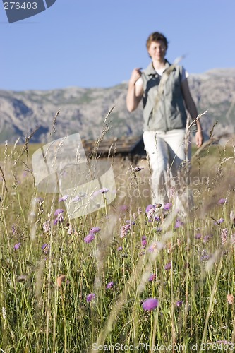 Image of Hiking woman in a mountain meadow