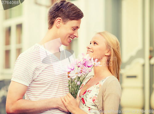 Image of couple with flowers in the city