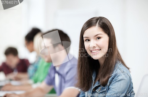 Image of student with computer studying at school