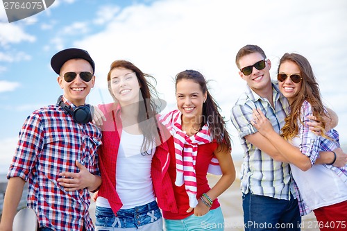 Image of group of smiling teenagers hanging out