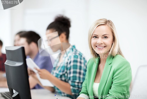 Image of student with computer studying at school