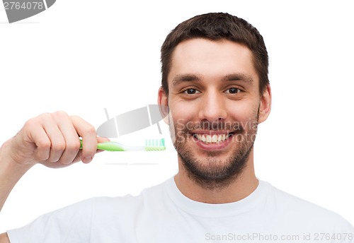 Image of smiling young man with toothbrush