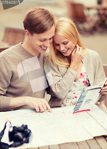 Image of couple with map, camera and travellers guide