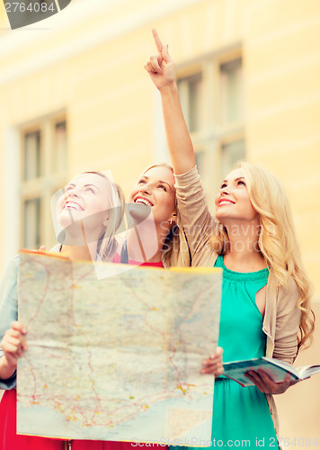 Image of beautiful women with tourist map in the city