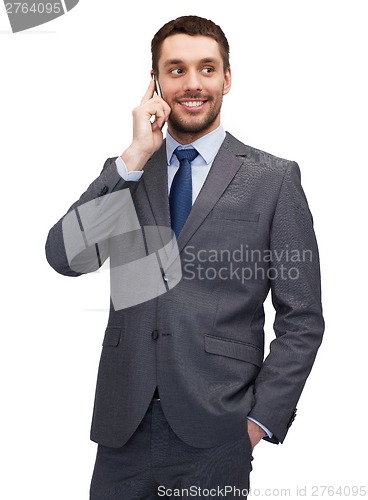 Image of young smiling businessman with smartphone
