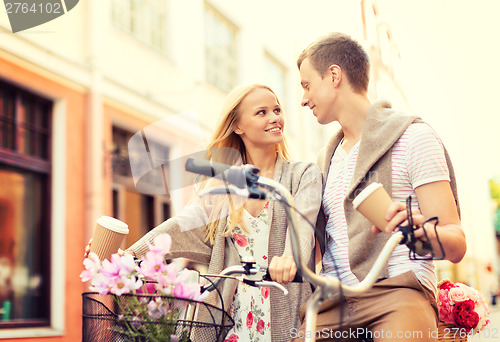 Image of couple with bicycles in the city