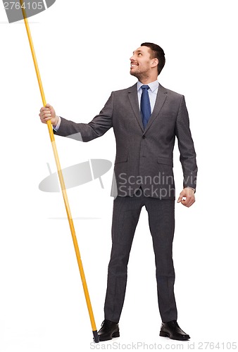 Image of smiling man holding flagpole with imaginary flag