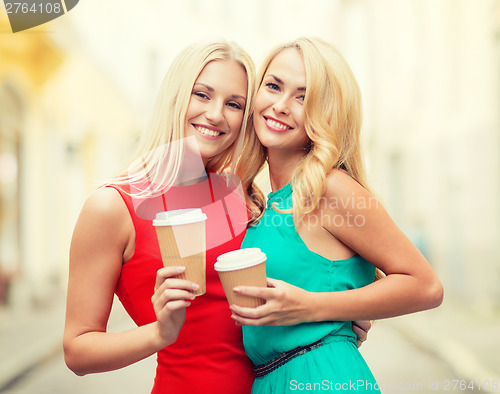 Image of women with takeaway coffee cups in the city