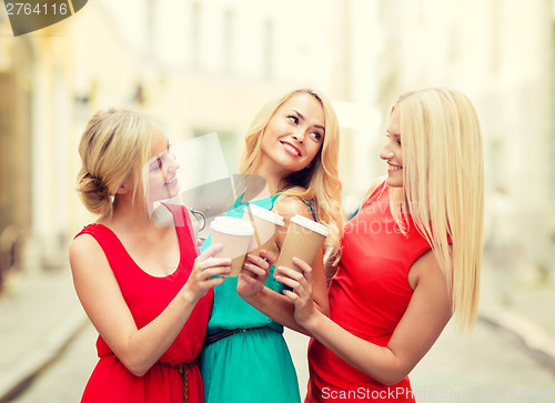 Image of women with takeaway coffee cups in the city