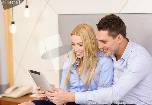 Image of couple with tablet pc computer in hotel room