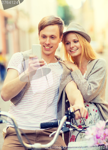 Image of couple with bicycles in the city