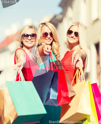 Image of beautiful women with shopping bags in the ctiy