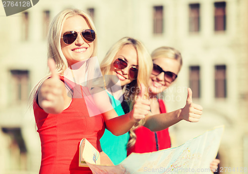 Image of beautiful women with tourist map in the city