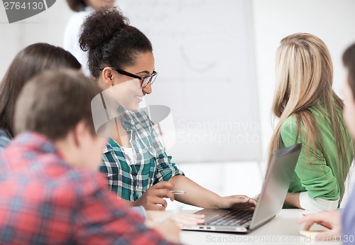 Image of african student girl with laptop at school