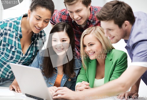 Image of students looking at tablet pc in lecture at school