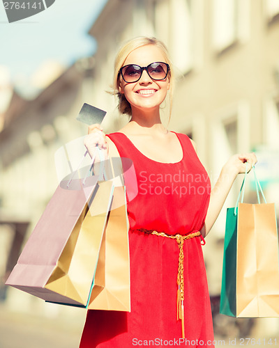 Image of beautiful woman with shopping bags in the ctiy