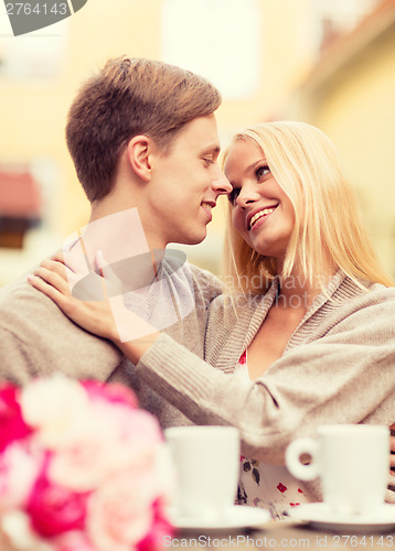 Image of romantic happy couple kissing in the cafe