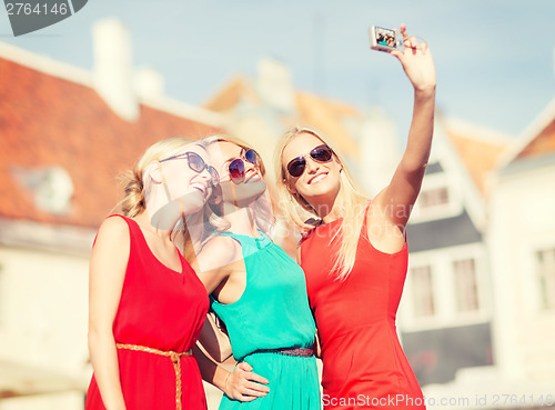 Image of beautiful girls taking picture in the city