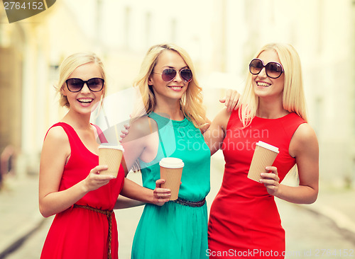 Image of women with takeaway coffee cups in the city