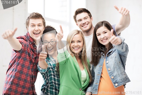 Image of students showing thumbs up at school