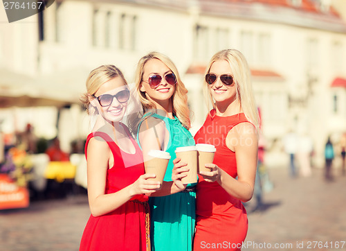 Image of women with takeaway coffee cups in the city