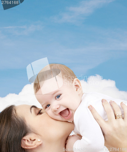 Image of laughing baby playing with mother