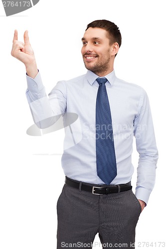Image of handsome buisnessman holding imaginary light bulb