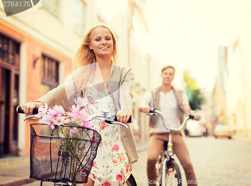 Image of couple with bicycles in the city