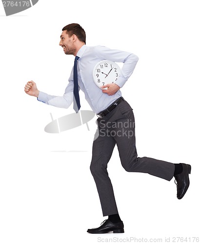 Image of smiling young businessman with clock running
