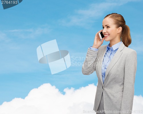 Image of young smiling businesswoman with smartphone