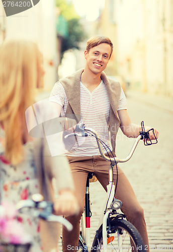 Image of couple with bicycles in the city