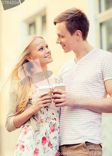 Image of couple in the city with takeaway coffee cups